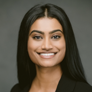 A smiling woman in a black jacket