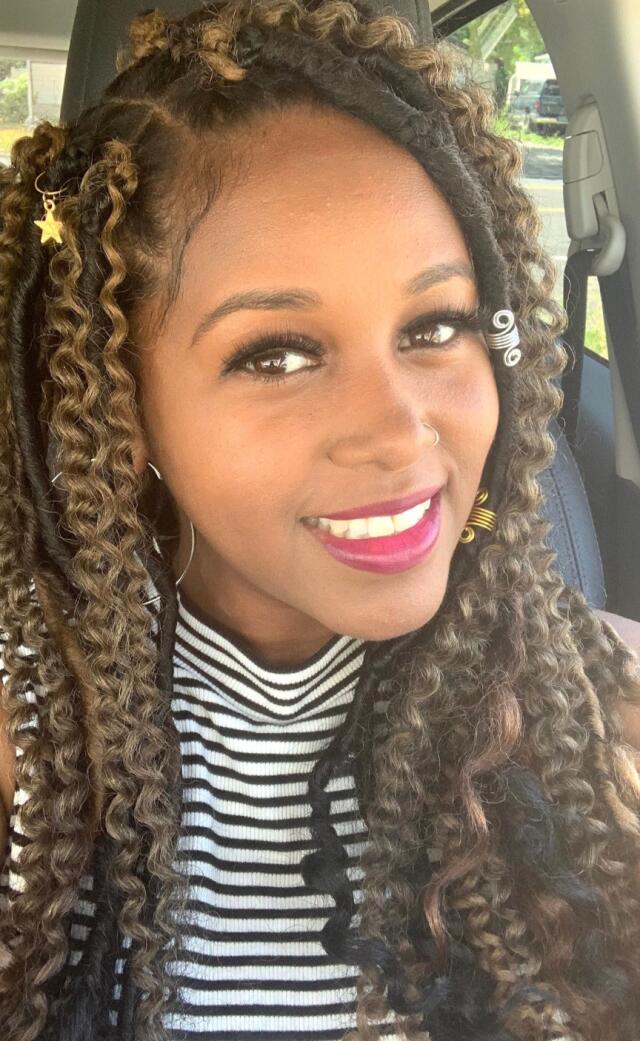 A smiling woman in a striped shirt